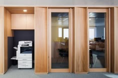 an office with wood paneling and glass doors