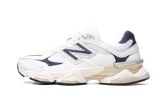 The New Balance 9060 "White/Navy" is a mostly two-tone, white-and-navy colorway of the popular, retro-looking lifestyle shoe.  Debuted in 2022 via a high-profile collaboration with Chicago based designer Joe Freshgoods, the 9060 was released in a plethora of appealing colorways thereafter, like this “White/Navy” style.  The shoe has a white mesh base and white, light grey, and navy leather overlays.  An oversized navy “N” logo appears on the mid-panel.  Other details include “NB” branding on the Nike X Travis Scott, Ugg Ultra Mini, New Balance 9060, Low Air Jordan 1, Jordan 8, Dunks Nike, Jordan 2, Logo New, Nike Dunk High