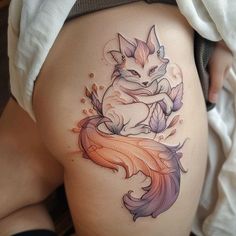 a woman's thigh with a fox tattoo on it