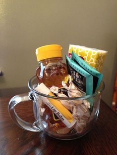 a glass cup filled with honey and other items