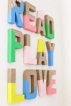 the word read play love spelled with colorful letters