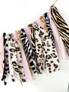 several pieces of animal print fabric hanging on a clothes line