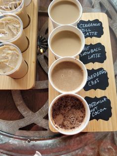 there are many different types of coffees on the table with their name written on them