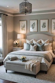 a large bed sitting in a bedroom next to two lamps and pictures on the wall