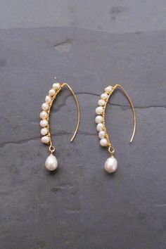 Long Baroque Pearl earrings. These long pearl earrings are made with cultured baroque freshwater pearls attached to a long earhook.  #dropearrings #earrings #pearljewelry #threaderearrings #hoopearrings Diy Back Drop Necklace, Handmade Delicate Pearl Earrings, Pearl Linear Long Drop Earrings, Long Drop Pearl Linear Earrings, Handmade Delicate Baroque Pearl Earrings, Baroque Pearl Drop Dangle Earrings, Handmade Baroque Pearl Earrings In Pearl White, Handmade Baroque Pearl White Earrings, Long Drop Pearl White Pearl Earrings