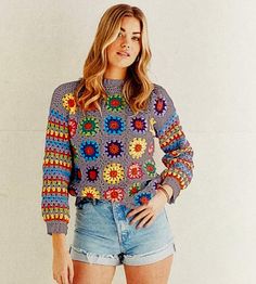 a woman wearing shorts and a colorful sweater