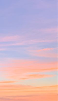 the sky is pink and blue with some white clouds in front of an orange sunset