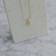 "Get yourself a lucky seven necklace for another lucky day. Dainty, cute and hard, made with gold plated titanium. Wear it alone or layer it with other necklaces. - Materials: 18K gold plated titanium - Length: the total length is approximately 16.5\" / 42cm plus 2\" / 5cm extension; the seven charm is about 0.43\" / 11mm x 0.23\" / 6mm - The product is tarnish-resistant and hypoallergenic Q&A 1. What is the material? - It is made from 18K real gold plated titanium. Titanium is nickel-free, Minimalist Tarnish-resistant Yellow Gold Charm Necklaces, Minimalist Gold Dog Tag Necklace, Lucky Number Necklace, Gold Nickel-free Charm Necklace For Good Luck, Yellow Gold Tarnish-resistant Dog Tag Necklace, Stacked Necklaces, Gold Charm Necklace, Gold Snake, Chain Anklet