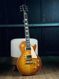 an electric guitar sitting on top of a wooden floor