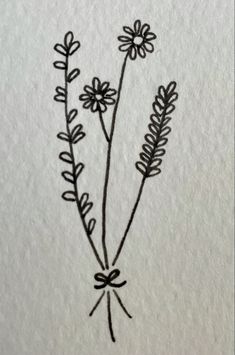 a drawing of some flowers on a piece of paper that is drawn with black ink