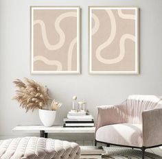 two paintings on the wall in a living room