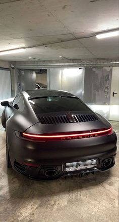 a black sports car parked in a parking garage