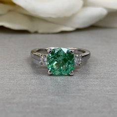 Paraiba Tourmaline Ring, Three Stone Engagement Ring, 14K White Gold, Cushion Cut Paraiba Ladies Ring, Paraiba And Moissanite Ring, #6869 #ThreeStone #ParaibaLadiesRing #ParaibaTourmaline #6869 #ParaibaRing #EngagementRing #MoissaniteRing #14kWhiteGold #CushionCutRing #WeddingRing Gia Certified Green Oval Sapphire Ring, Green Cushion Cut Emerald Ring With Accent Stones, Green Cushion Cut Diamond Ring With Center Stone, Gia Certified Tourmaline Wedding Ring, Wedding Gia Certified Tourmaline Ring, Green Sapphire Ring Gia Certified For Wedding, Gia Certified Green Cushion Cut Rings, Paraiba Tourmaline Engagement Ring, Paraiba Tourmaline Ring