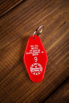 a red luggage tag sitting on top of a wooden table