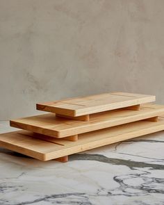 three wooden trays stacked on top of each other