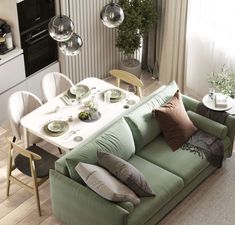 a living room filled with furniture next to a kitchen and dining room table in front of a window