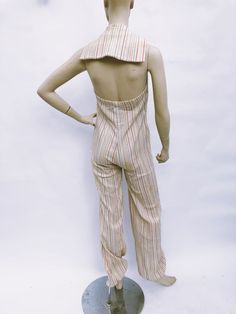 Fun retro summer jumpsuit from the 70's. Made of a gauze like material, this jumpsuit features red vintage buttons down the front and a backless bodice.Gathered ankle length pants.So retro!This jumpsuit is a modern size small and is good vintage condition. Please check measurements:Bust: 32-34""Waist: 28"Hips: freeLength: 63" 80s Skirt, Summer Jumpsuit, Fur Trim Coat, Womens Jumpsuits, Cocktail Dress Vintage, Jumpsuit Summer, Retro Summer, Striped Jumpsuit, 70s Retro