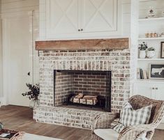 a living room with a fire place and chairs