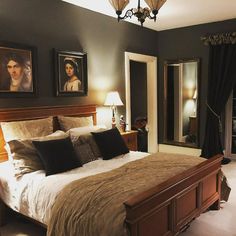 a bedroom with a large bed and pictures on the wall