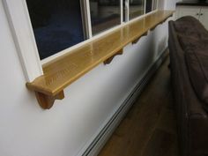 a wooden shelf sitting next to a window