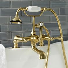 an old fashioned bathtub faucet with shower head and handset in gold