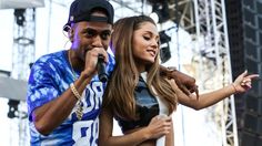 a man and woman standing next to each other on stage with microphones in their hands