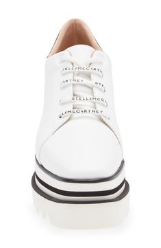 A sporty faux-leather sneaker from Stella McCartney features a perforated-logo at the heel collar, a chunky, striped platform and a sawtooth-edged rubber sole. 3 1/2" (89mm) heel; 2 1/2" platform (size 8.5US / 38.5EU) Synthetic upper, lining and sole Made in Spain Women's Designer Shoes White Leather Lace-up Wedge Sneakers, White Lace-up Leather Wedge Sneakers, White Leather Round Toe Wedge Sneakers, White Low-top Leather Wedge Sneakers, Modern White Wedge Sneakers With Contrast Sole, Sporty Leather Wedge Sneakers With Laces, Modern Leather Platform Sneakers With Laces, White Leather Wedge Sneakers With Perforated Toe Box, Leather High-top Platform Sneakers With Perforations