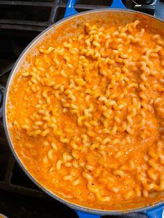 macaroni and cheese is being cooked on the stove