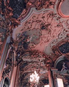 an ornately decorated room with chandeliers and paintings on the ceiling is shown