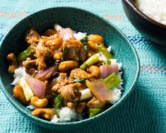 a blue bowl filled with rice and meat