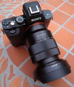 a sony camera sitting on top of a tiled floor