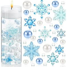 a candle and some snowflakes are next to each other