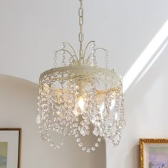 a chandelier hanging from the ceiling in a room