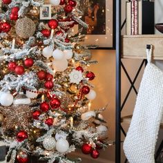 a christmas tree decorated with red, white and silver ornaments