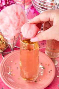 Adding the cotton candy glitter ball to the cocktail by hand. Disco Ball Cocktail, Cotton Candy Glitter, Cotton Candy Cocktail, Fruity Alcohol Drinks, Strawberry Simple Syrup, Whipped Cream Vodka