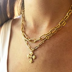 This Cross is inspired by a 7th century antique that depicted haloed saints at each end of the cross. We love the regal feel with a modern interpretation. This double layer chain in brass plated in a matte gold finish. The shorter chain is 16" and the longer chain is 17". Has a 3" extension for adjustable length. All orders over $50 ship for free within the USA. All orders usually ship within 24 hrs from the USA. Gold Metal Cross Necklace With Clavicle Chain, Elegant Gold Cross Necklace With Chain, Gold Metal Cross Jewelry, Gold Cross-shaped Metal Jewelry, Gold Cross Chain Necklace Elegant Style, Elegant Gold Cross Chain Necklace, Gold Metal Cross Necklace With Adjustable Chain, Gold Brass Cross Jewelry, Gold Metal Crucifix Cross Necklace