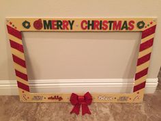 a merry christmas photo frame with a red bow on the bottom and green lettering that reads,