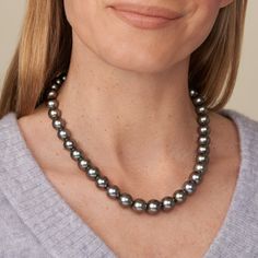 This one-of-a-kind necklace is composed of round, AAA quality Tahitian pearls measuring 10.0-12.3 mm in diameter and approximately 18 inches in length including the clasp. The light to medium green strand has peacock overtones, sharp luster, very clean surfaces, and the pearls are arranged to complement their individual beauty. Your strand will arrive double-knotted on color-matching silk. The knots protect your pearls from rubbing against each other, and if your necklace ever breaks, you won't Classic Tahitian Pearl Necklace With Round Beads, Tahitian Pearl Necklace With Single Strand Of Round Beads, Classic Tahitian Pearl Round Bead Necklaces, Tahitian Pearl Single Strand Necklace, Classic Tahitian Pearl Necklace With High Luster, Tahitian Pearl Round Beads Formal Necklace, Classic Tahitian Pearl Round Bead Necklace, Formal Tahitian Pearl Necklaces With Round Beads, Formal Tahitian Pearl Round Bead Necklaces