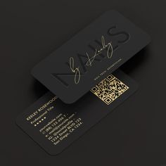 two black business cards with gold foil on the front and back, one has a qr code