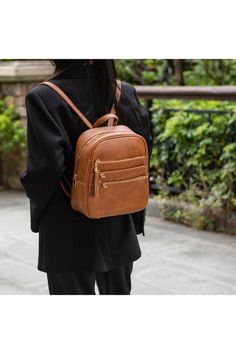 DETAILS: High-quality vegan leather Gold-tone hardwareLarge Backpack: 10" W x 11 H x 4.75" DMini Backpack: 3.75" W x 8.5 H x 3.5" DWristlet Pouch: 8" W x 4.75"HInterior details: features a wall zip pocket and one slip pocketExterior details: Exterior features three zippered pocketsExterior details- Mini Backpack: Exterior features three zippered pocketsFabric LiningZipper fastening Style: Casual Print / Pattern: Solid Embellishment: Pocket Closure: Zipper Dimensions (inch):One Size: 6.3 (Length) Fall Backpack With Adjustable Strap, Trendy Faux Leather Backpack With Zipper Pocket, School Backpack With Adjustable Strap For Fall, Fall School Backpack With Adjustable Strap, Fall Satchel Backpack For Daily Use, Trendy Standard Backpack For Fall, Standard Backpack For School In Fall, Fall Standard Backpack, Fall School Standard Backpack