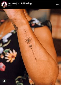 a woman with a flower tattoo on her arm