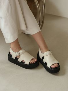 Editor's Notethen is Artistic and sensuous high-end contemporary designer shoe brand.- Wide strap on the instep gives a stable fit- Buckle strap on the ankle- Soft and durable cow leather used- Casual and chunky mood black soleMeasurements (in.)- Size: KR 225MM - KR 255MM (US 5.5 - 8.5)- Heel Height: 0.98 in. (Front) / 1.57 in. (Back)Composition & Care- Upper: Leather / Lining: Synthetic Leather / Outsole: Rubber Sole- Natural leather may have fine scratches and wrinkles- Bright leather can Modern Slingback Sandals With Round Toe And Heel Strap, Modern Chunky Platform Sandals With Open Heel, Modern Closed Toe Slingback Sandals With Platform, Modern Closed Toe Platform Slingback Sandals, Modern Heels With Leather Footbed, Modern Slingback Sandals With Buckle Closure, Modern Leather Platform Slingback Sandals, Leather Slingback Sandals With Chunky Platform, Leather Slingback Heels With Chunky Platform