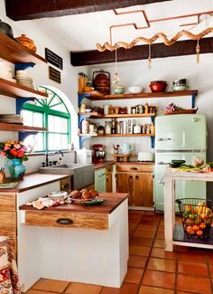 an old fashioned kitchen with lots of wooden shelves