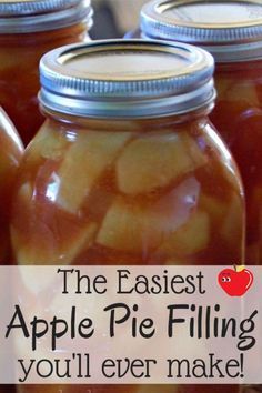 jars filled with apple pie filling sitting on top of a table