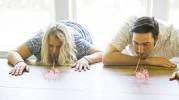 two people laying on the floor with their hands in front of them