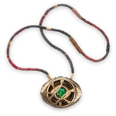 a necklace with a green stone in the center on a cord that is attached to it