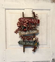 a sign that says north pole, sleigh rides and toy shop on it