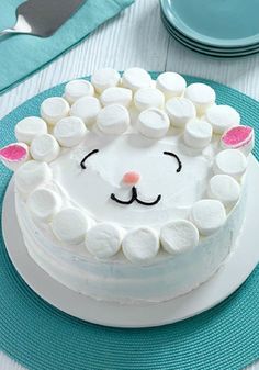 a cake decorated with marshmallows and a sheep face