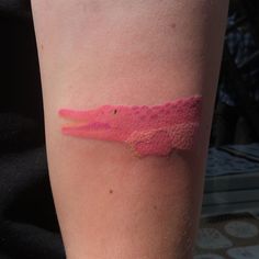 a woman's arm with a pink lipstick swatch on her left side,