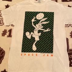 Space Jam T-Shirt Size Medium Juniors *Juniors Sizes Run Smaller* 90s Style White T-shirt With Front Print, White Relaxed Fit T-shirt For Fans, White Dtg Printed 90s Tops, 90s Style Pre-shrunk White T-shirt, 90s White Fan Merchandise T-shirt, 90s White T-shirt With Logo Print, Retro White T-shirt For Fan Merchandise, White Screen Print Tops For Fan Merchandise, White Cotton T-shirt For Fan Merchandise